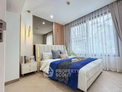 Luxurious bedroom with elegant decor and large window offering city views, perfect for urban living.