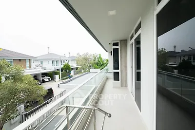 Spacious balcony with modern railing and neighborhood view