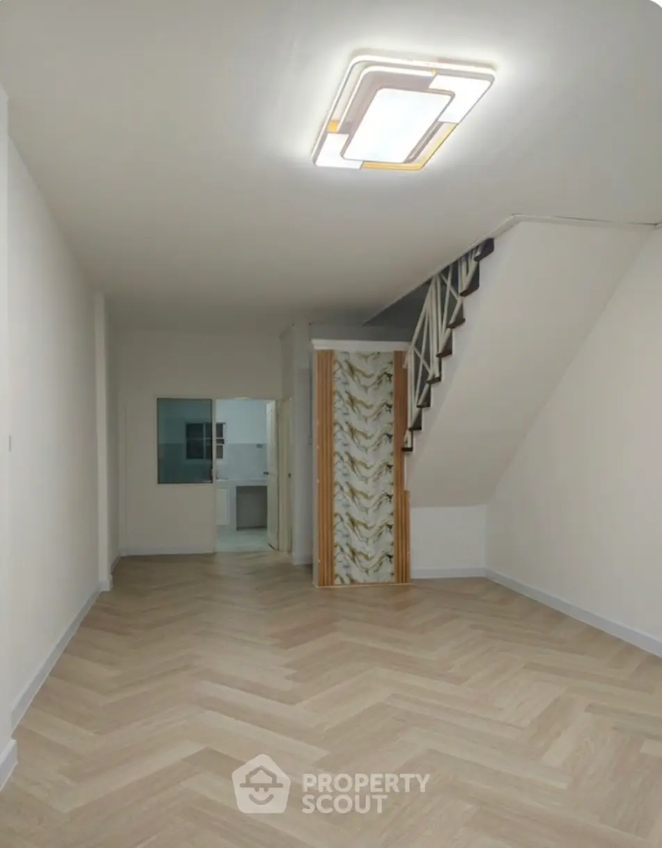 Spacious interior with modern flooring and staircase, ideal for stylish living.