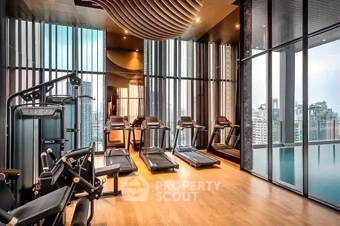 Luxurious high-rise gym with modern equipment and stunning city views.
