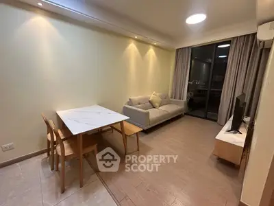 Modern living room with stylish furniture and large window offering city view