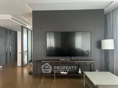 Modern living room with large flat-screen TV and elegant decor