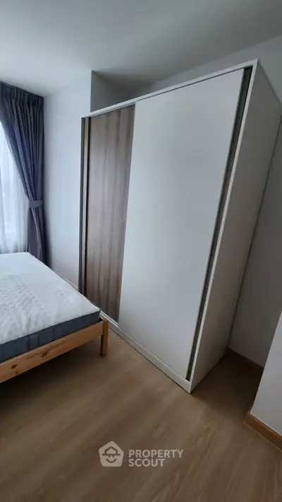 Modern bedroom with sleek wardrobe and cozy bed setup