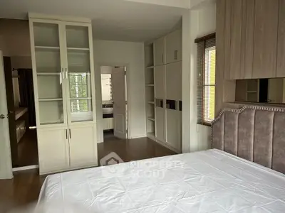 Spacious bedroom with elegant built-in wardrobes and natural light