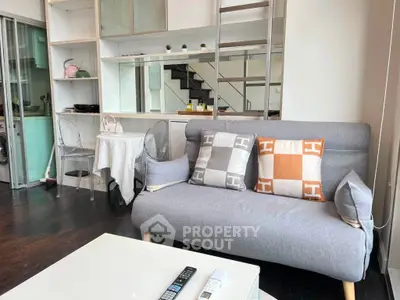 Modern living room with stylish sofa and loft-style shelving in a cozy apartment.