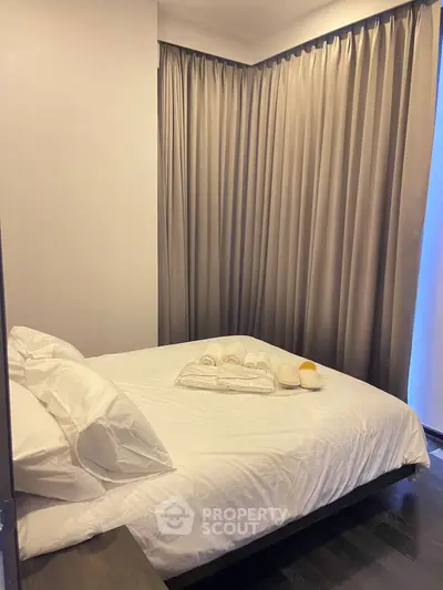 Cozy bedroom with plush bedding and elegant curtains, perfect for restful nights.