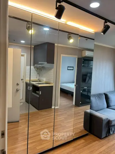 Modern apartment interior with mirrored closet and cozy living area
