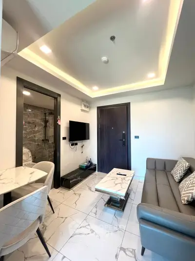 Modern living room with sleek furniture and marble flooring in a stylish apartment.