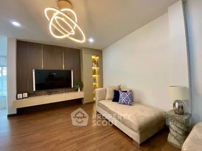 Modern living room with stylish lighting and cozy seating area, perfect for relaxation.