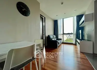 Modern living room with wooden flooring and large window view