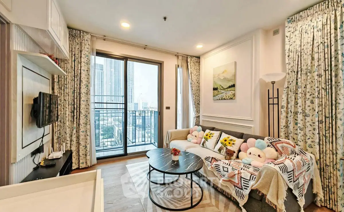 Charming living room with balcony view in modern apartment, featuring cozy decor and ample natural light.