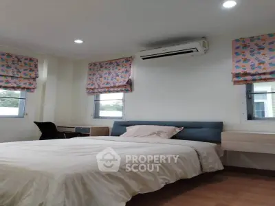 Cozy bedroom with modern decor and air conditioning, perfect for relaxation.