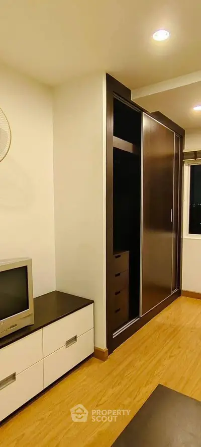 Modern bedroom with built-in wardrobe and sleek TV stand