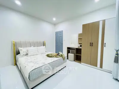 Modern bedroom with stylish decor and ample storage space