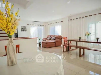 Spacious living room with elegant decor and abundant natural light