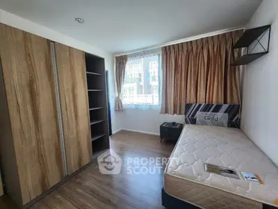Spacious bedroom with wooden flooring and large wardrobe