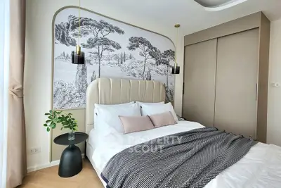 Luxurious bedroom with elegant decor and stylish wall art, featuring a cozy bed and modern lighting.