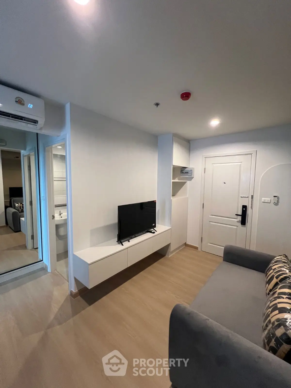 Modern living room with sleek TV setup and cozy sofa, perfect for relaxation.