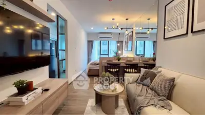 Modern living room with stylish decor and open layout, featuring a cozy sofa and wall-mounted TV.