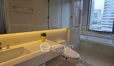 Modern bathroom with city view, featuring sleek fixtures and a spacious shower area.