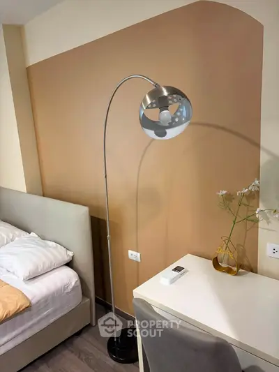 Modern bedroom with stylish floor lamp and cozy decor