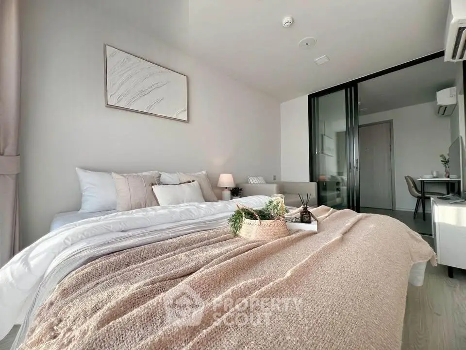 Luxurious bedroom with elegant decor and natural light, featuring a cozy bed and stylish furnishings.