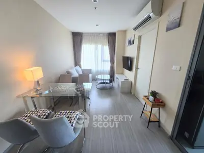 Modern living room with stylish furniture and natural light, perfect for relaxation and entertainment.