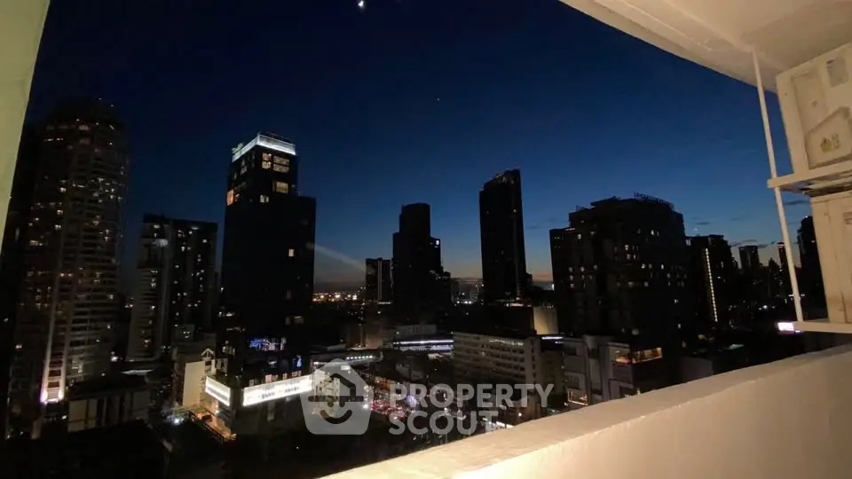 Stunning city skyline view from a high-rise balcony at dusk, showcasing urban living.