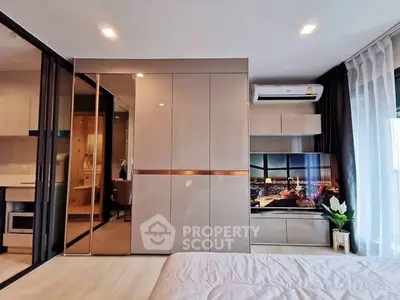 Modern bedroom with sleek design, built-in wardrobe, and city view from window.