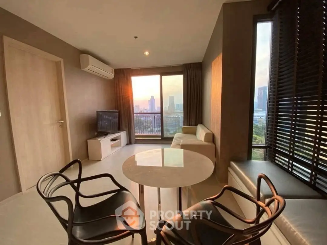 Modern living room with city view, stylish furniture, and natural light.