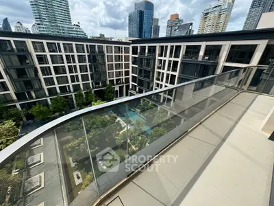 Stunning urban view from a modern balcony overlooking a luxurious pool and garden area.