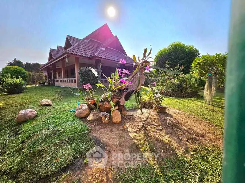 Charming garden view of a traditional house with lush greenery and vibrant flowers.