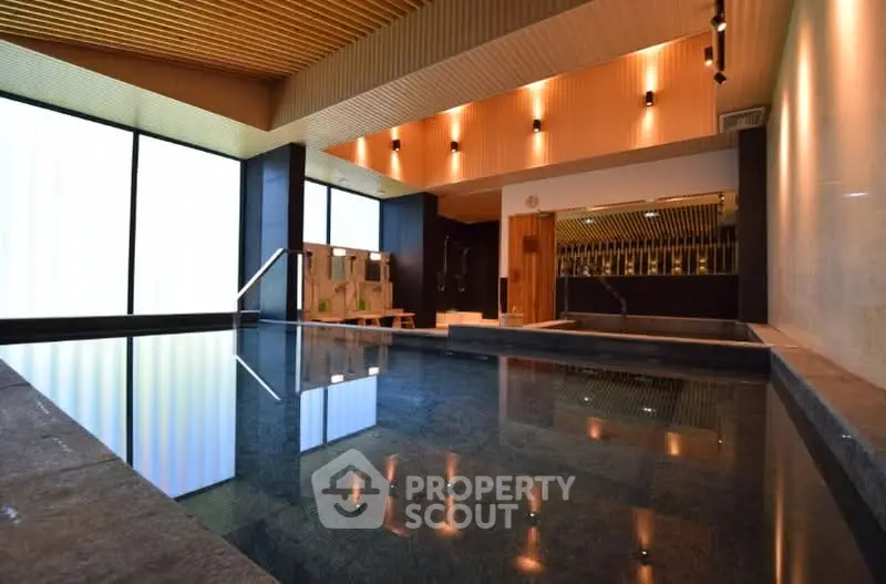 Luxurious indoor pool area with modern design and ambient lighting, perfect for relaxation and leisure.