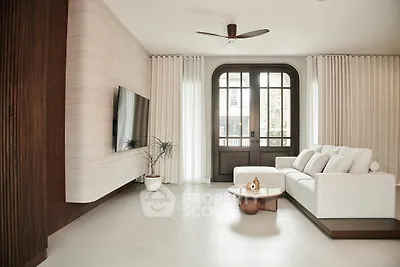 Elegant living room with modern decor and large windows