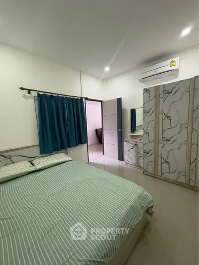 Modern bedroom with stylish marble-patterned wardrobe and air conditioning
