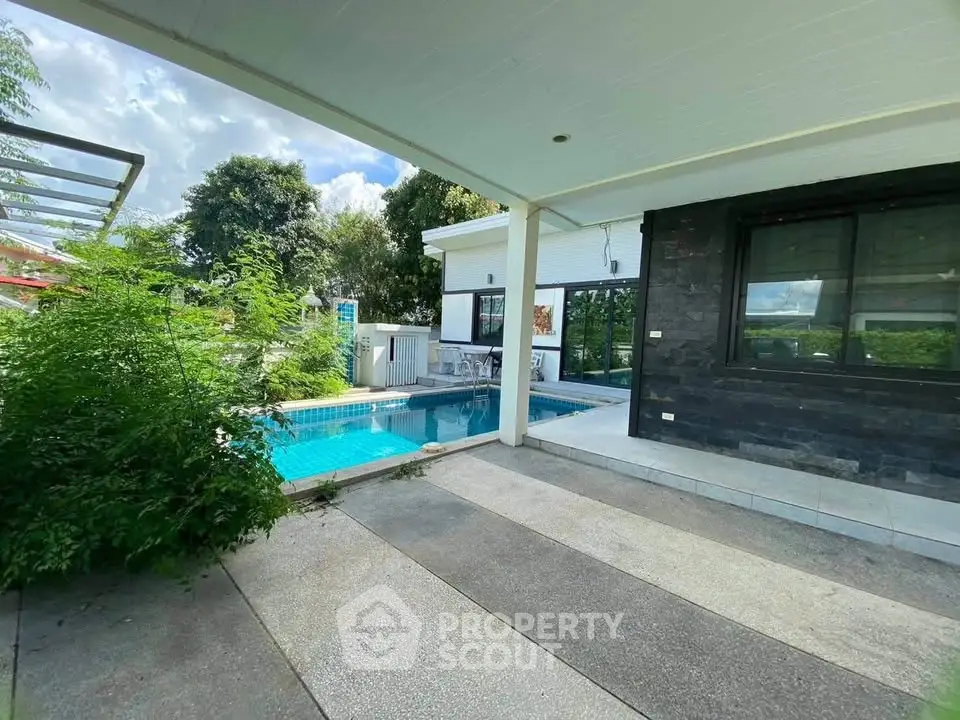 Modern home with private pool and lush garden, perfect for relaxation and luxury living.