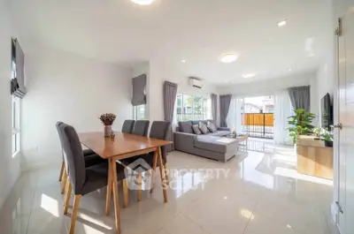 Spacious modern living room with dining area and large windows for natural light