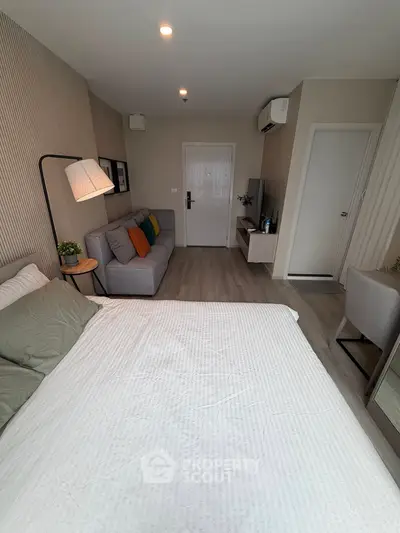 Modern studio apartment with cozy living area and stylish decor