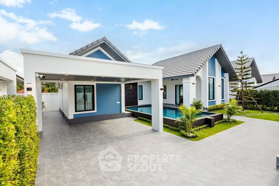 Modern single-story house with sleek design, pool, and spacious driveway in a serene neighborhood.