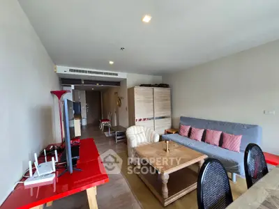 Spacious living room with modern furniture and natural light, perfect for relaxation and entertainment.