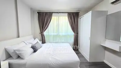 Bright and cozy bedroom with modern decor and ample natural light