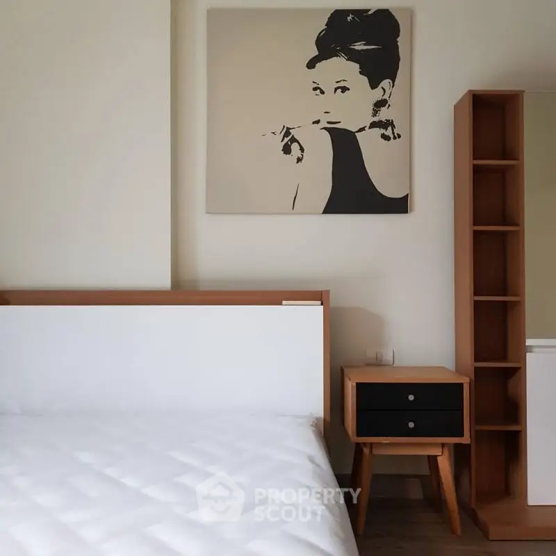 Modern bedroom with stylish wooden furniture and elegant wall art