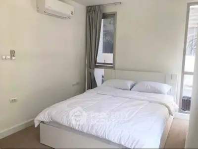 Modern minimalist bedroom with air conditioning and natural light