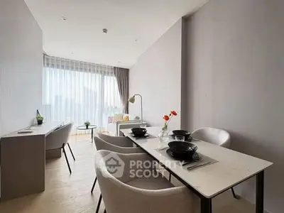 Modern dining area with elegant table setting and natural light in contemporary apartment.