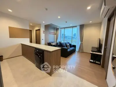 Modern open-plan living room with city view and sleek interior design