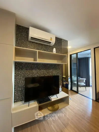 Modern living room with sleek TV unit and air conditioning in stylish apartment