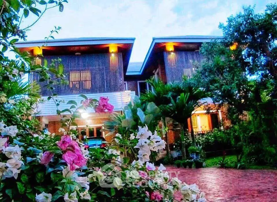 Stunning modern two-story home with lush garden and vibrant flowers, perfect for serene living.
