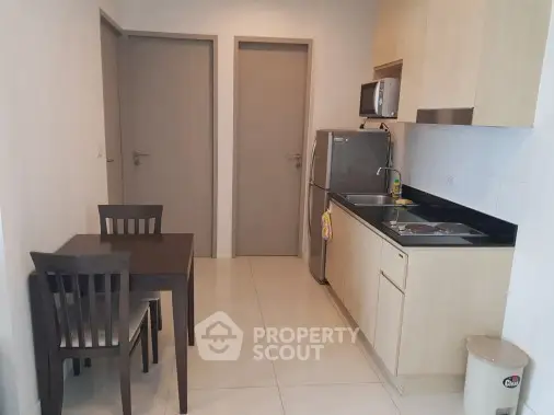Modern compact kitchen with dining area in a cozy apartment
