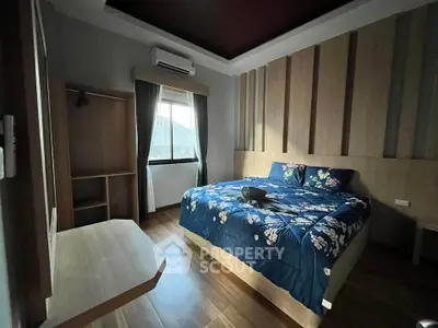 Cozy bedroom with wooden accents and large bed in modern apartment