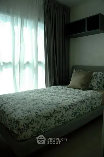 Cozy bedroom with floral bedding and soft natural light